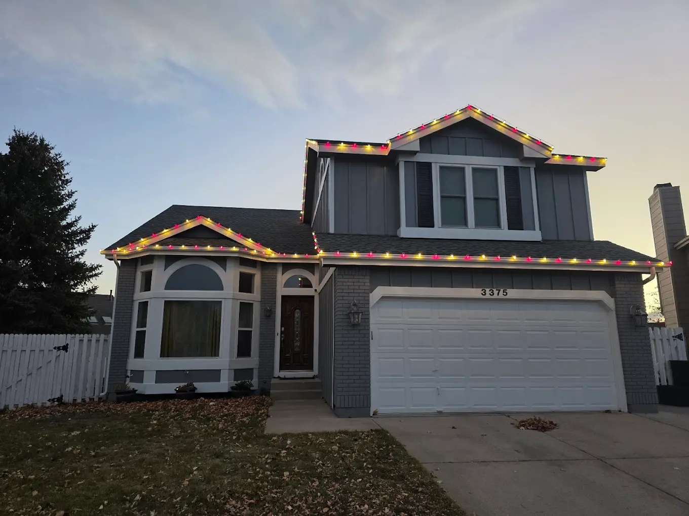 Multicolor LED roofline on a two-story home — Front Range portfolio example