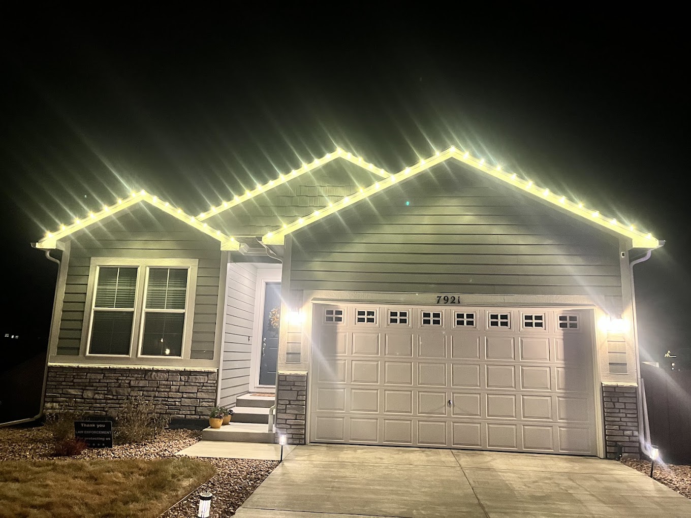 Warm white roofline Christmas light installation on a Colorado Front Range home by Christmas Lights Colorado Springs
